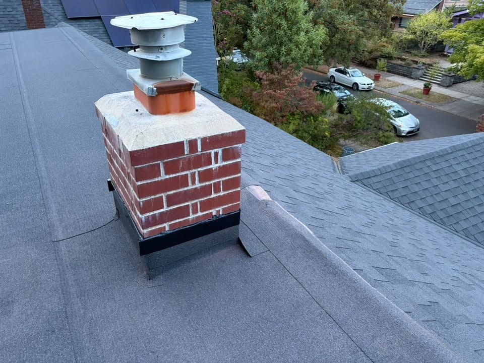 Flat roof system around a brick chimney